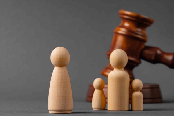 wooden pieces representing a family facing legal divorce and custody battles