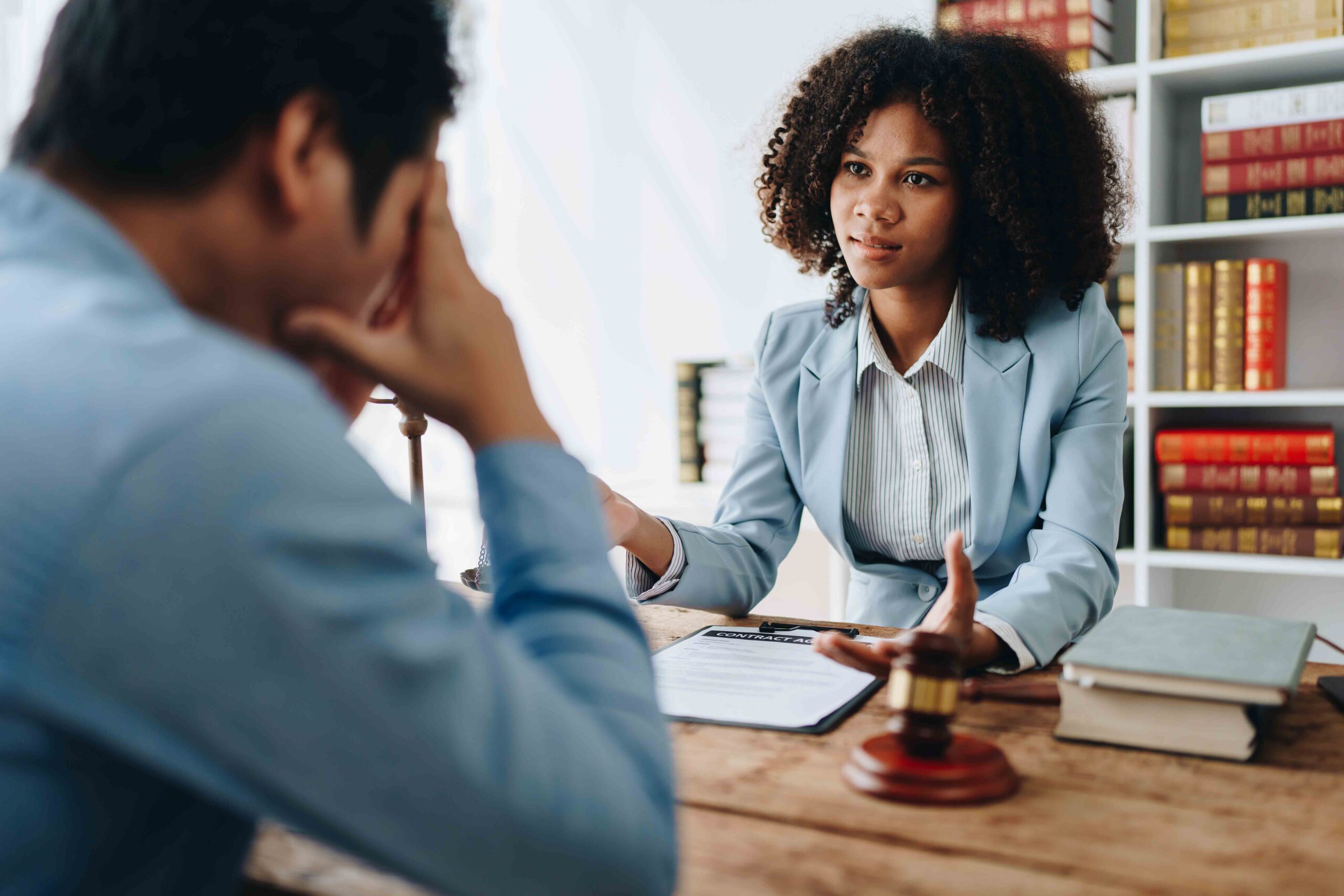 A stressed father consulting with an attorney in a legal office, about his paternity rights despite not having his name on the child's birth certificate.