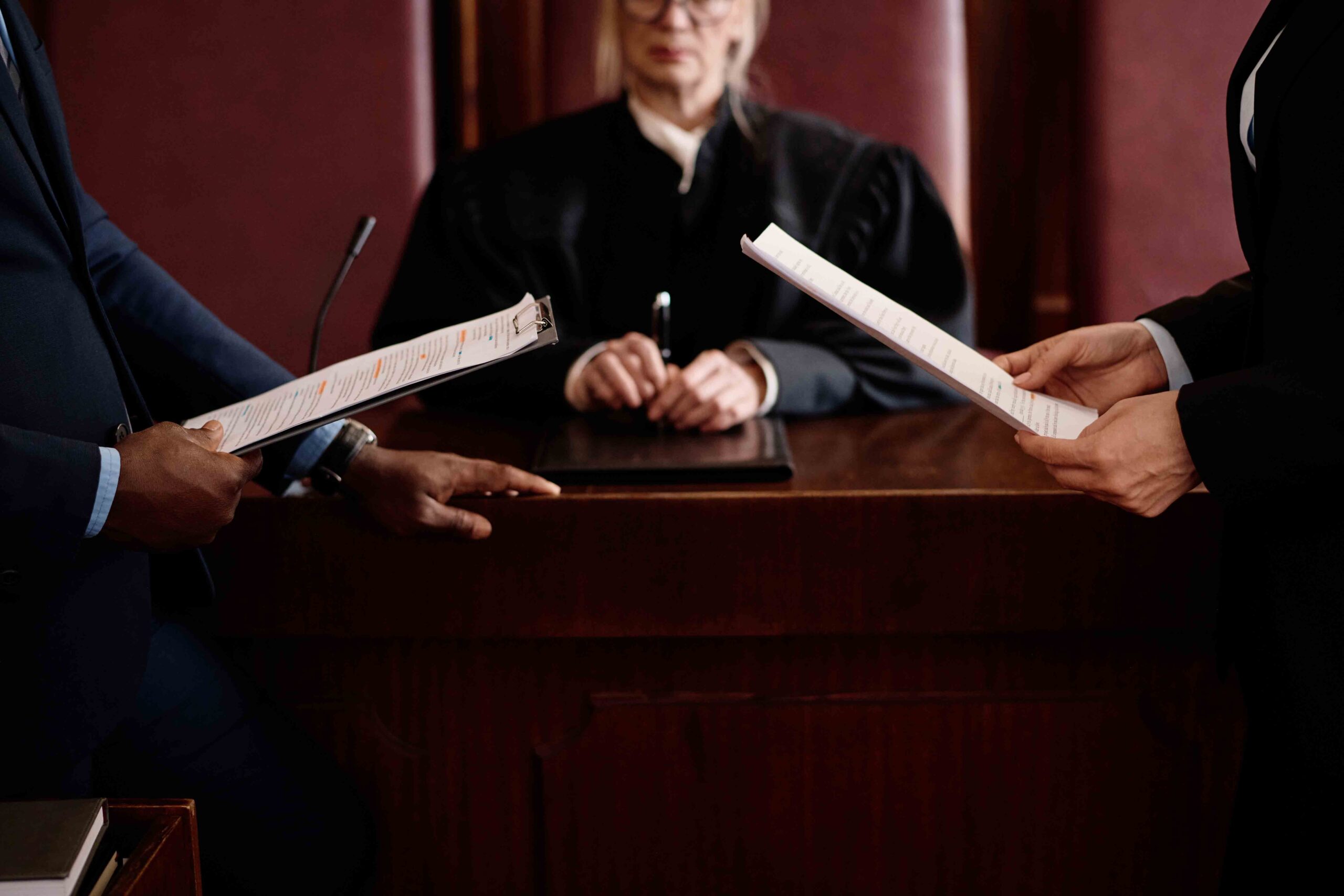 Two lawyers presenting documents to a judge in a courtroom, a conclusion for legal paternity.