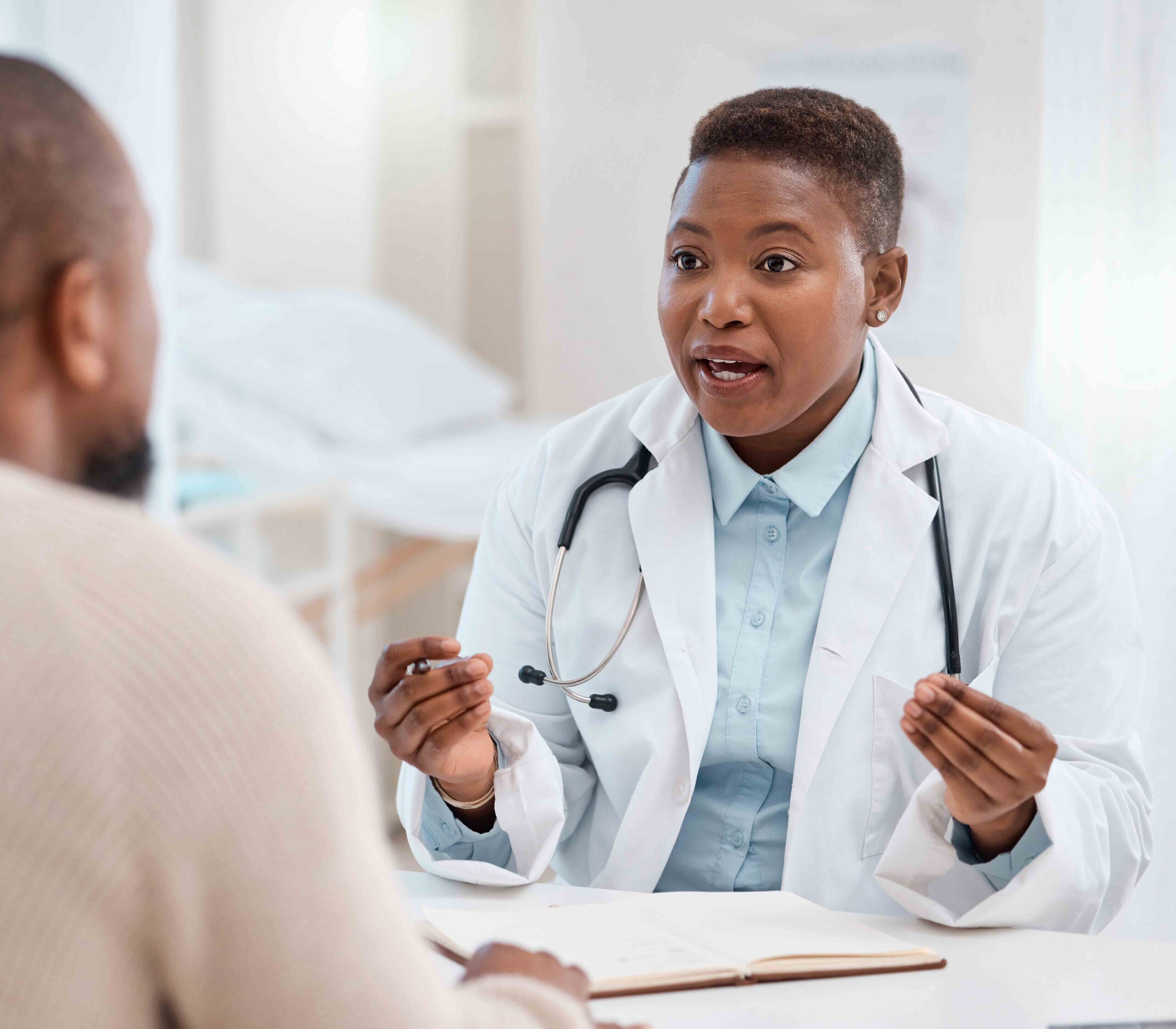 Doctor discussing genetic health risks with a patient during a consultation.