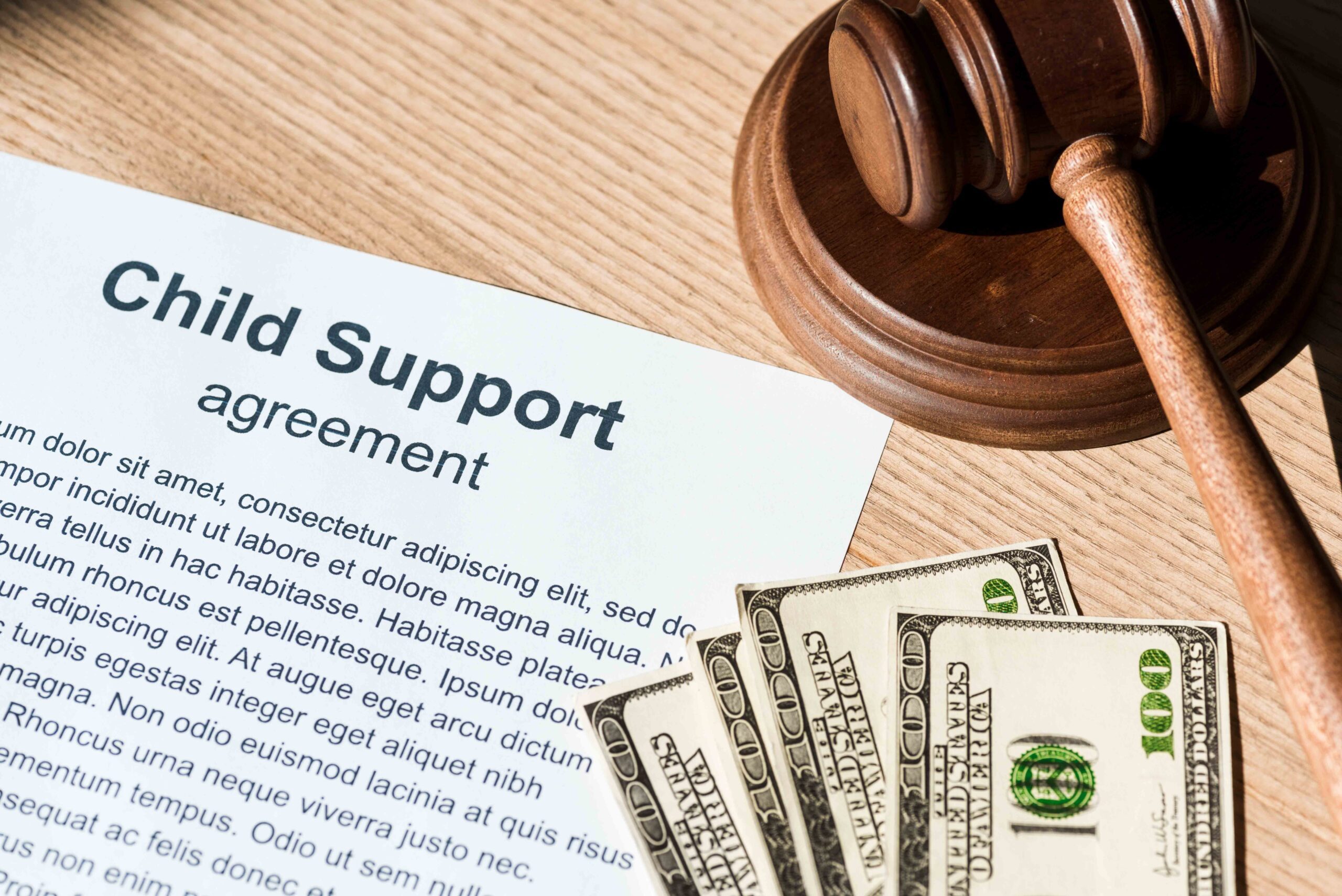 Child support agreement document with cash and a gavel, illustrating steps to handle retroactive child support claims.