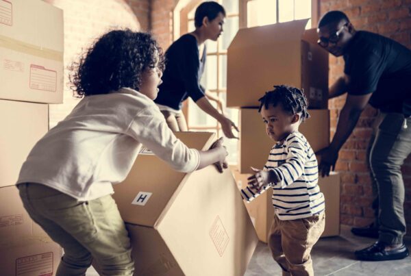 A family unpacking boxes, symbolizing stability and relocation in child custody cases.