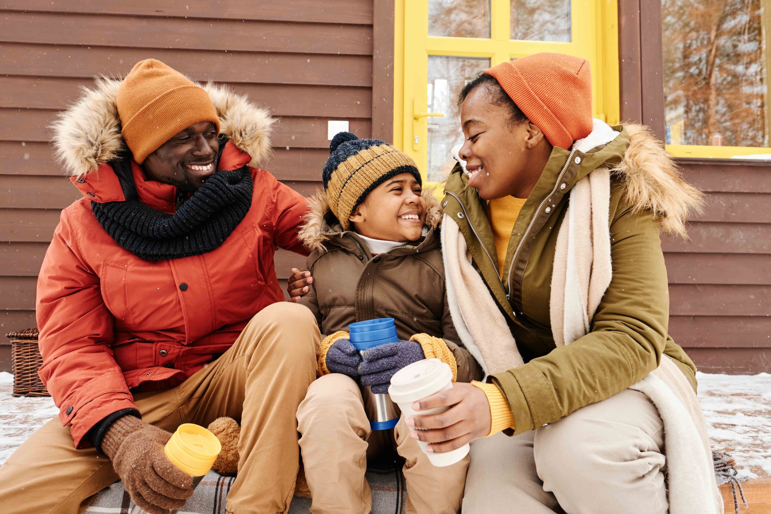 A happy family in winterwear sitting together, representing joint custody arrangements and family bonding.