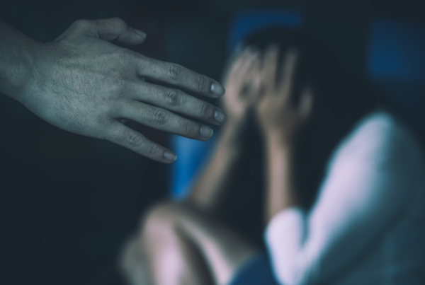 Person in distress with an outstretched hand symbolizing the need for legal protection in Texas