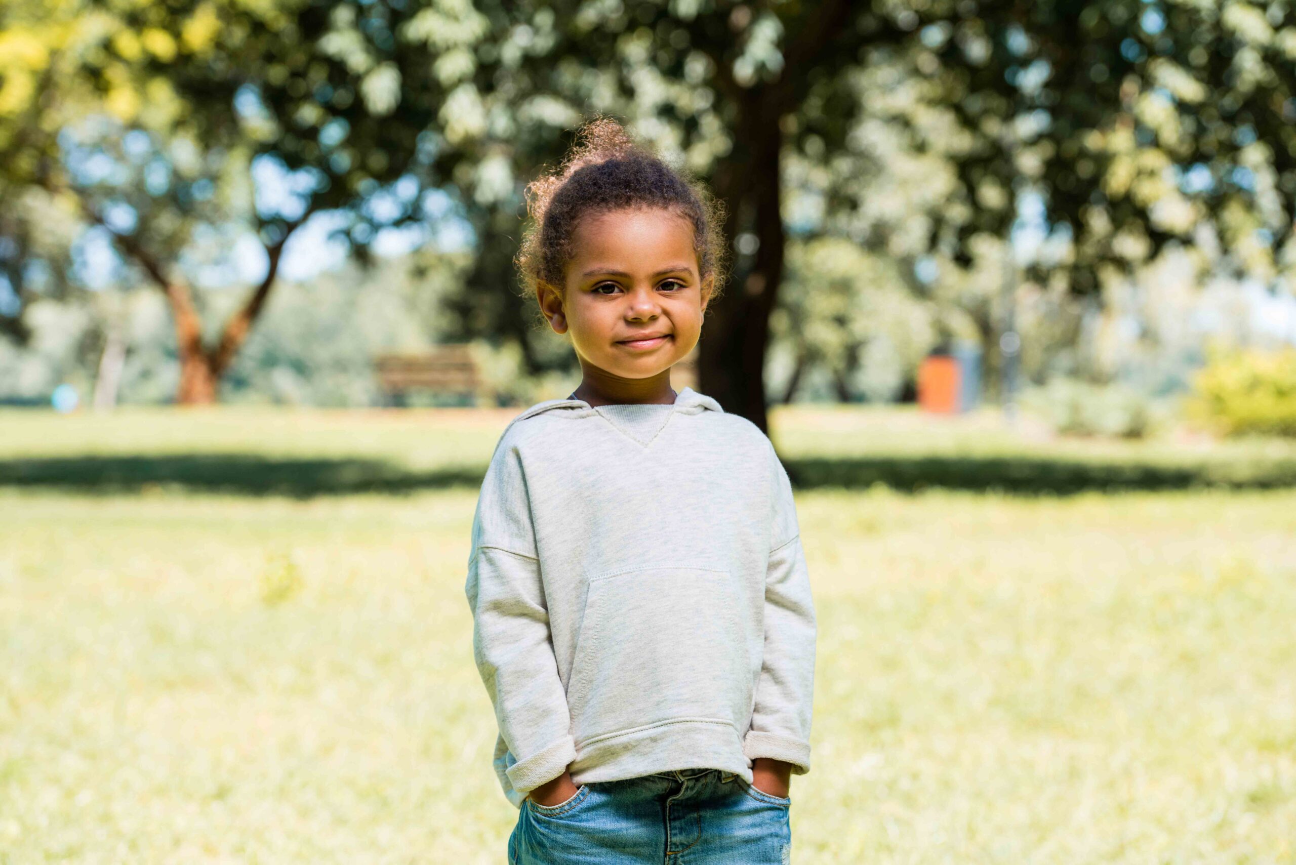 Adorable child in jeans and a sweater, illustrating factors considered by the court in temporary custody decisions.