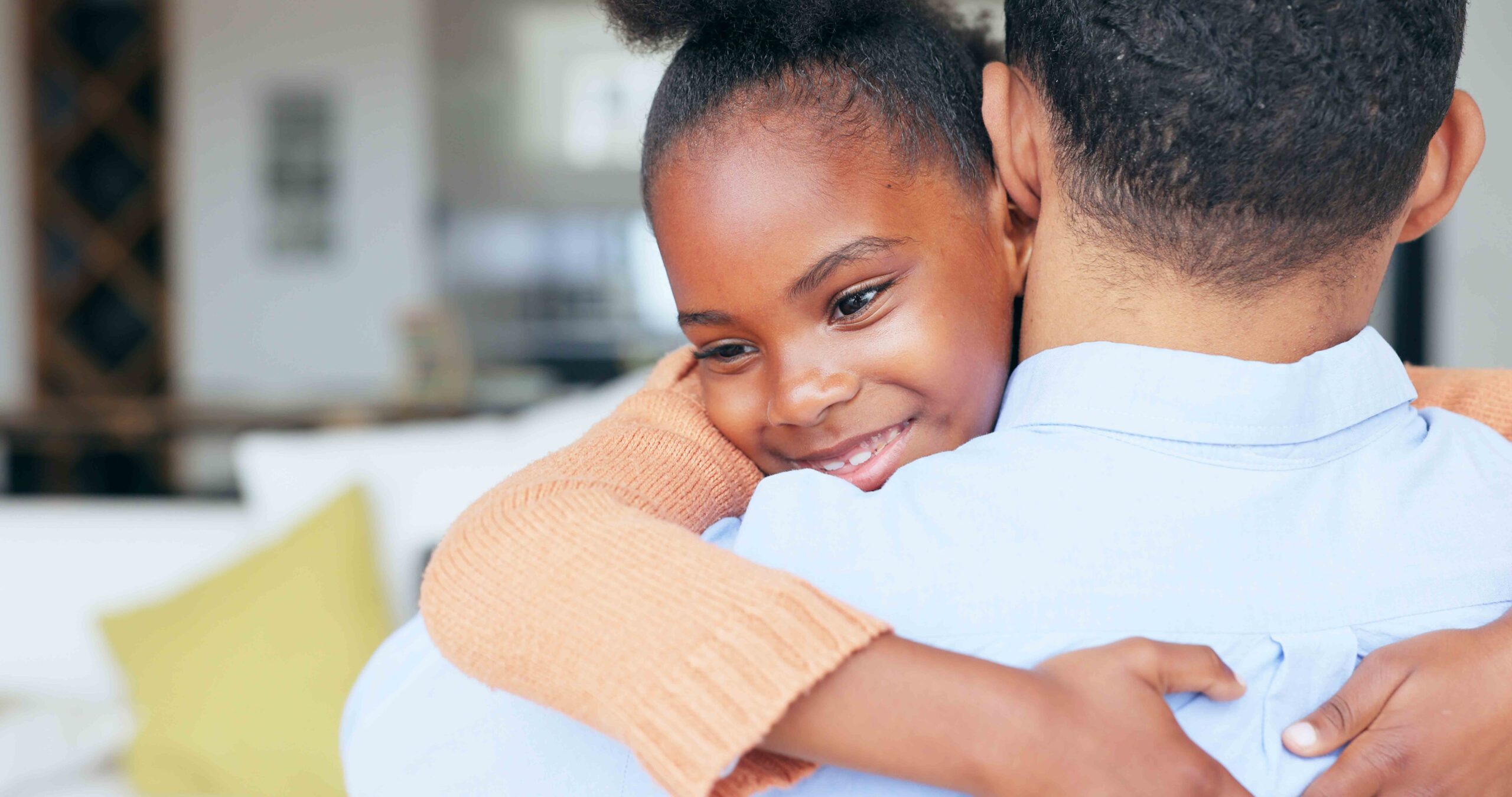 A closeup of a father and daughter hugging, emphasizing the importance of child custody arrangements in prenuptial agreements.