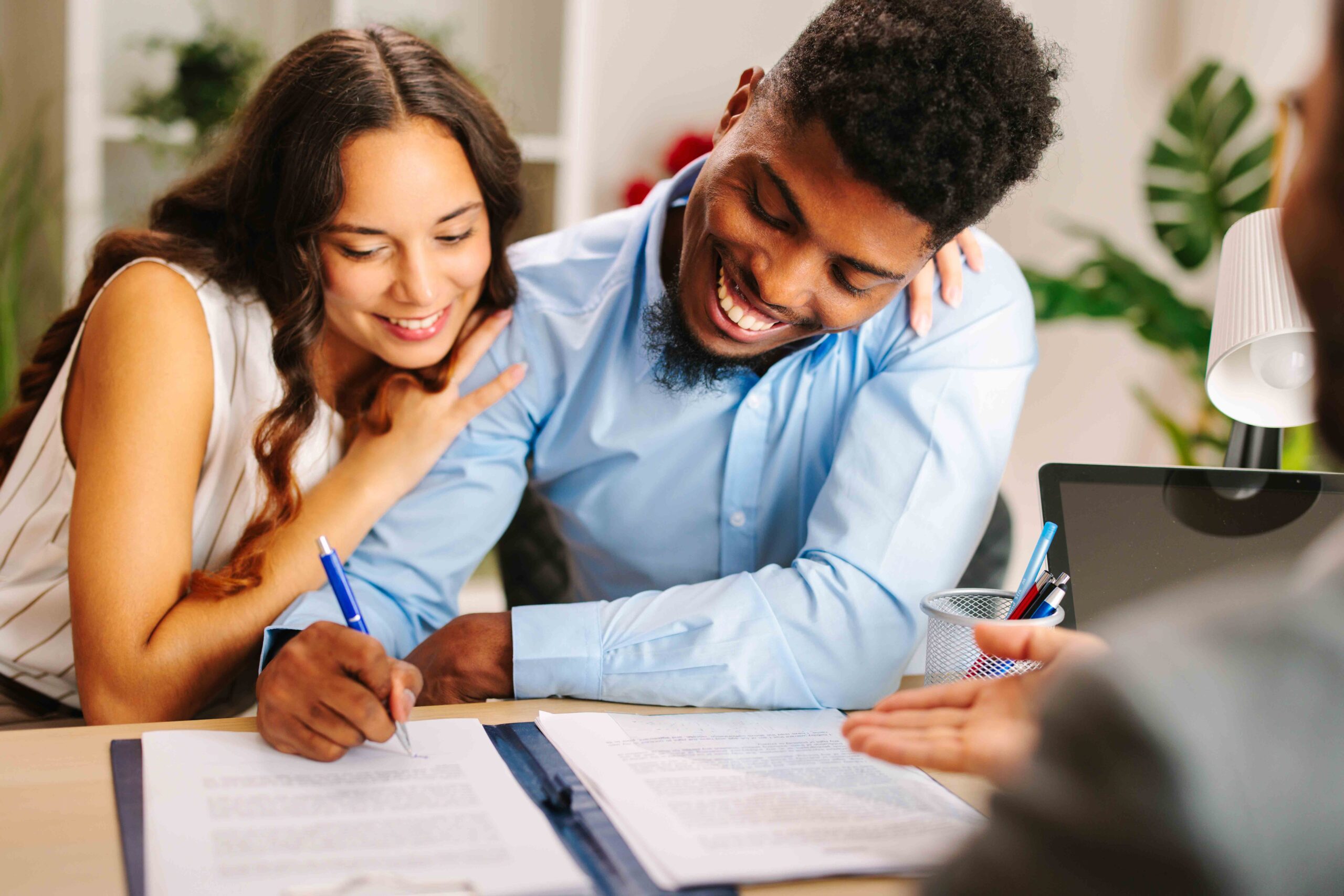 Young American couple signing a contract, highlighting the importance of proper execution for a valid prenuptial agreement