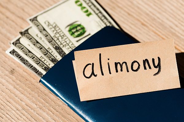 Stack of cash with a card labeled 'alimony,' representing financial support after divorce