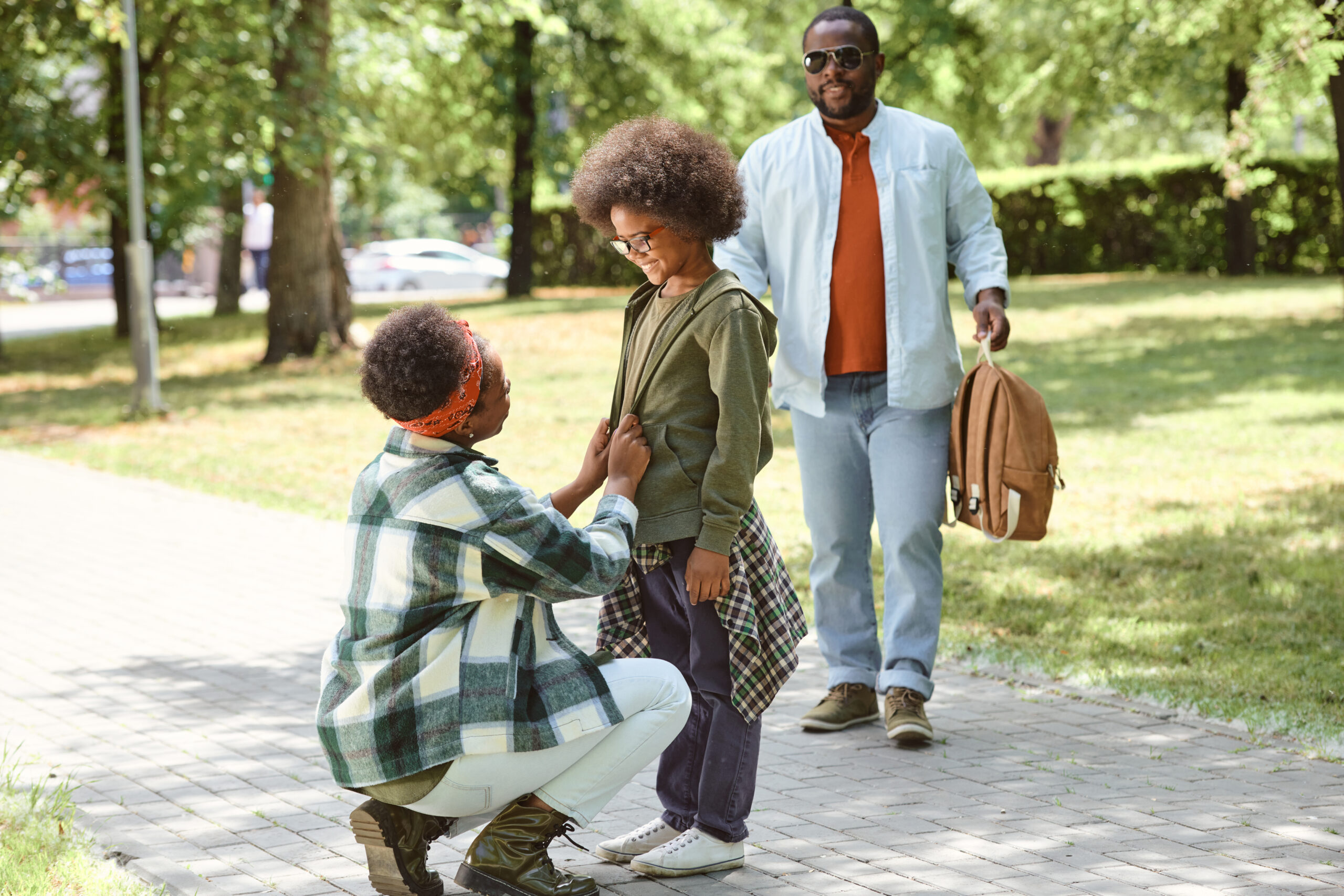 Parents and child spending time outdoors, symbolizing the importance of parental involvement in shaping custody agreements during mediation