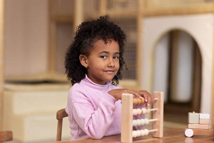 Young girl playing with educational toys at daycare, symbolizing the financial support provided through child support