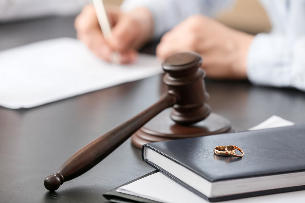 Gavel and wedding ring on legal documents, symbolizing annulment as a legal process to void a marriage in Texas due to fraud or other reasons