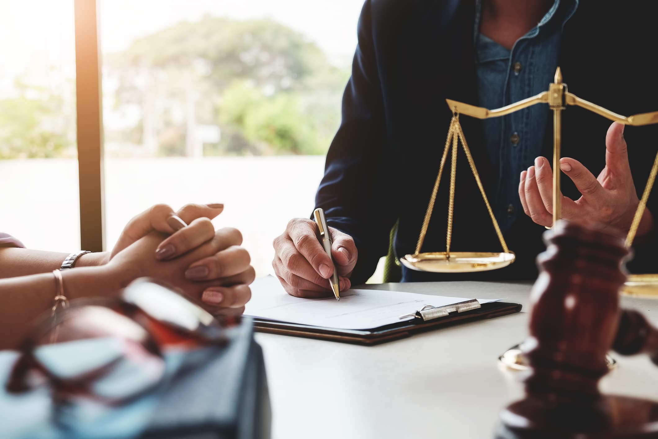 Closeup of a lawyer discussing to a client the legal implications of annulment vs. divorce and financial consequences