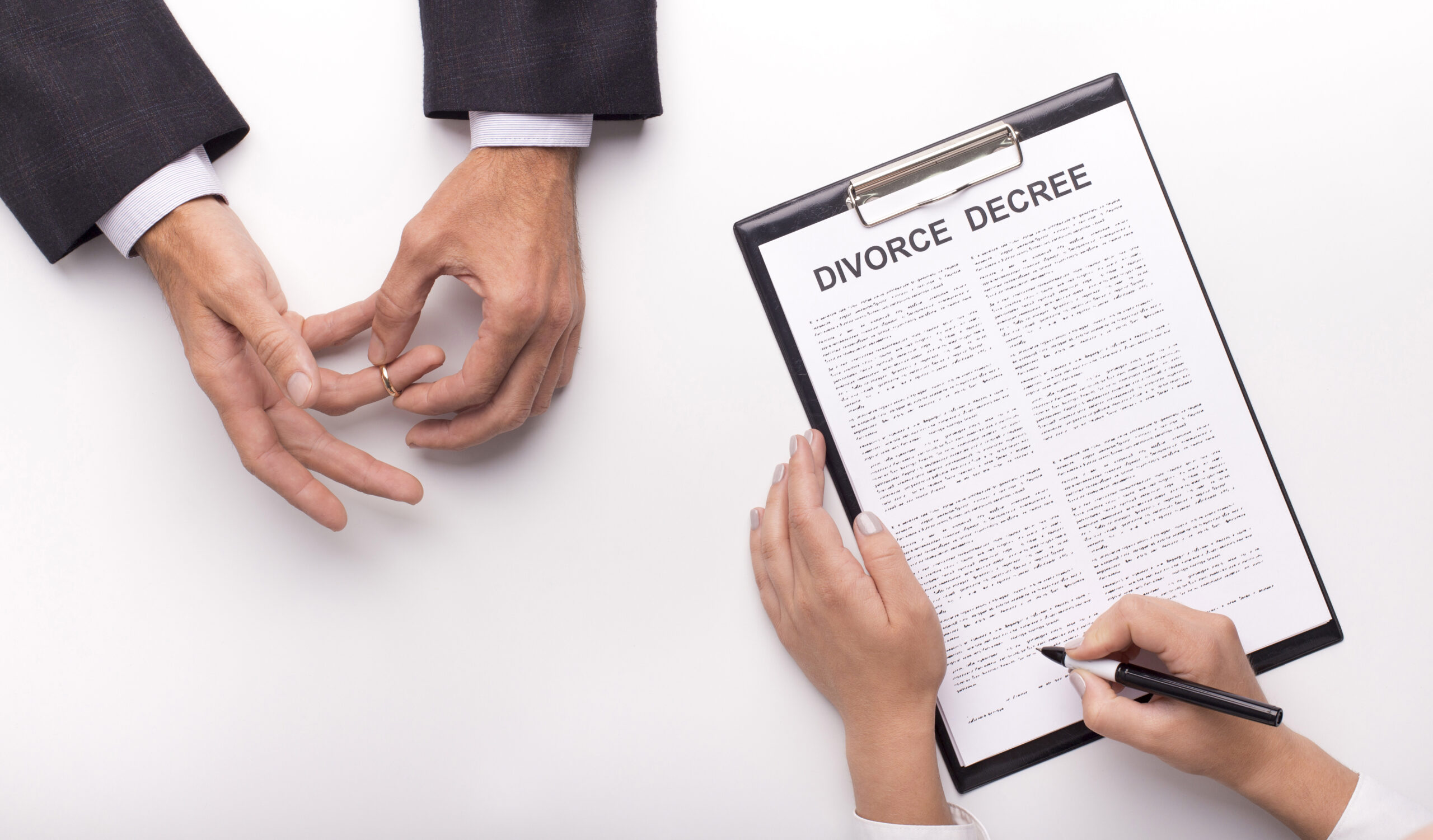 A closeup of a woman signing a divorce decree with a man removing his wedding ring, representing the legal termination of a valid marriage