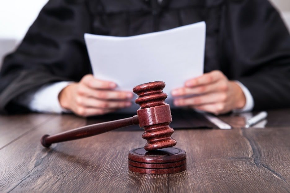 A judge reading a file about protection order of the victim in texas