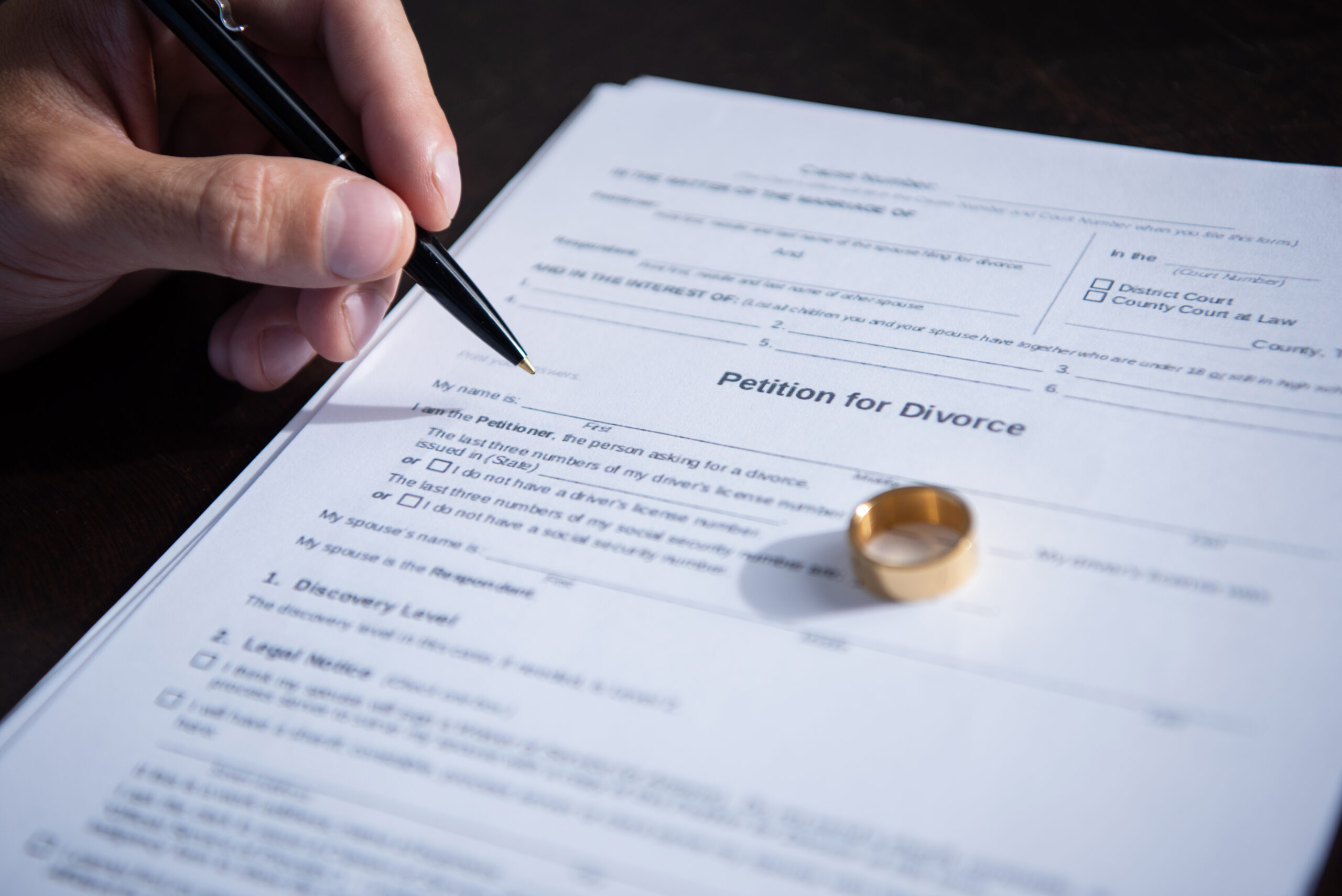 A marriage certificate alongside a wedding ring, symbolizing the union that may lead to considerations of divorce without a lawyer