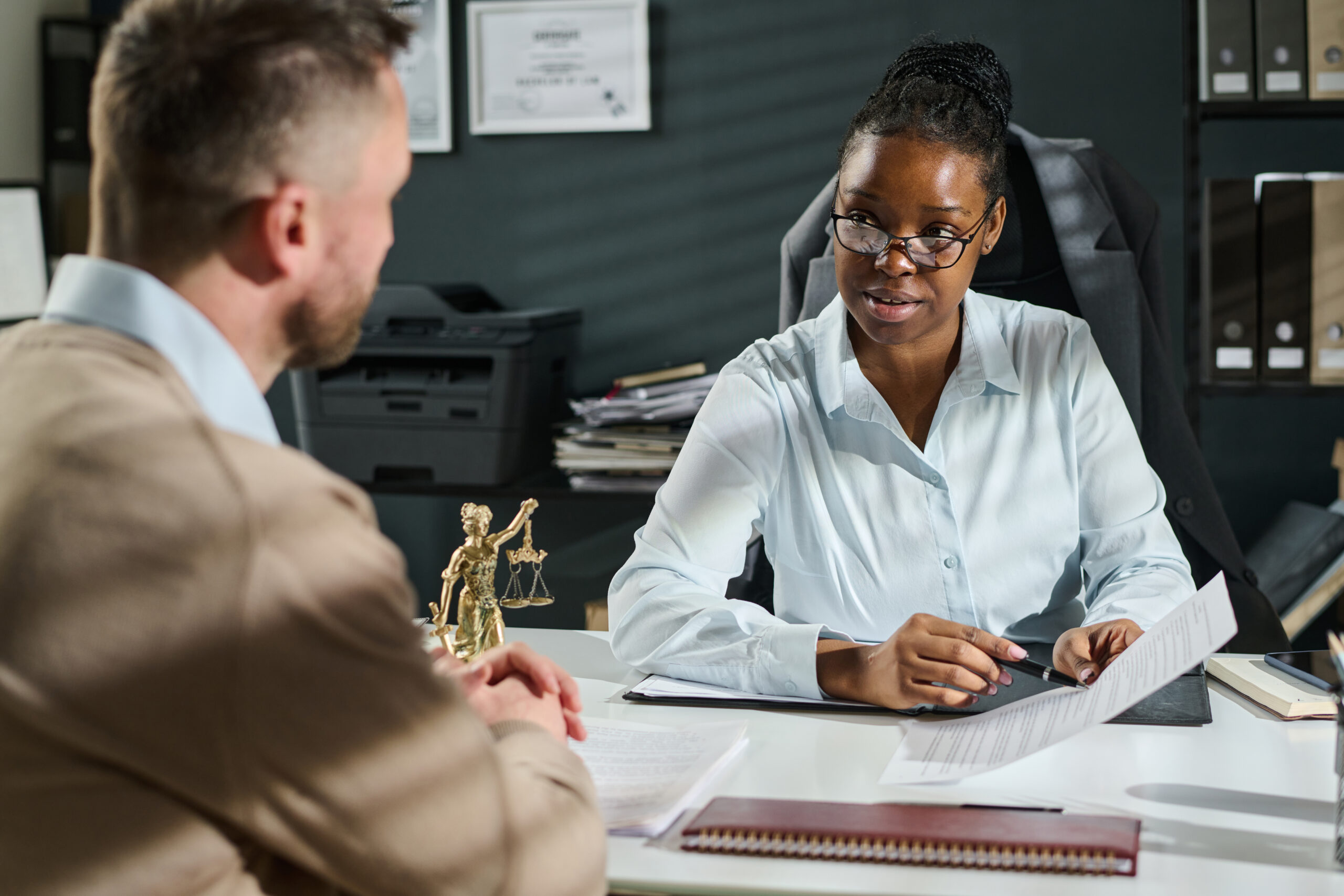 A woman and man in an office engaged in a discussion about a divorce case without a lawyer present