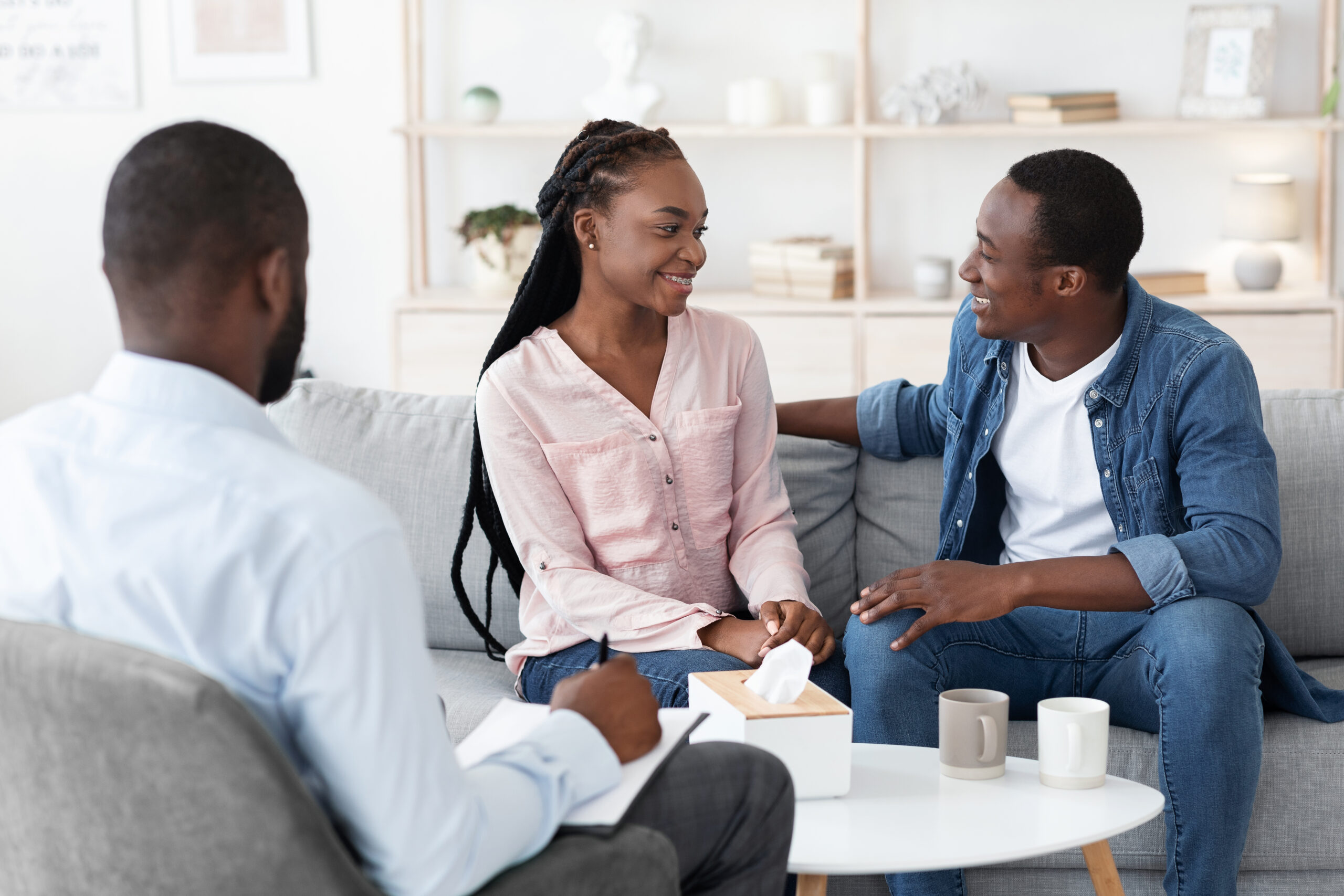 A couple discussing their relationship with a therapist, exploring options for a prenuptial agreement