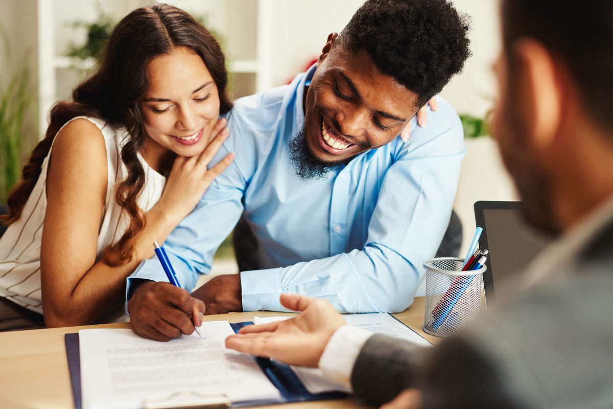 young couple signing a pre-nuptial agreement