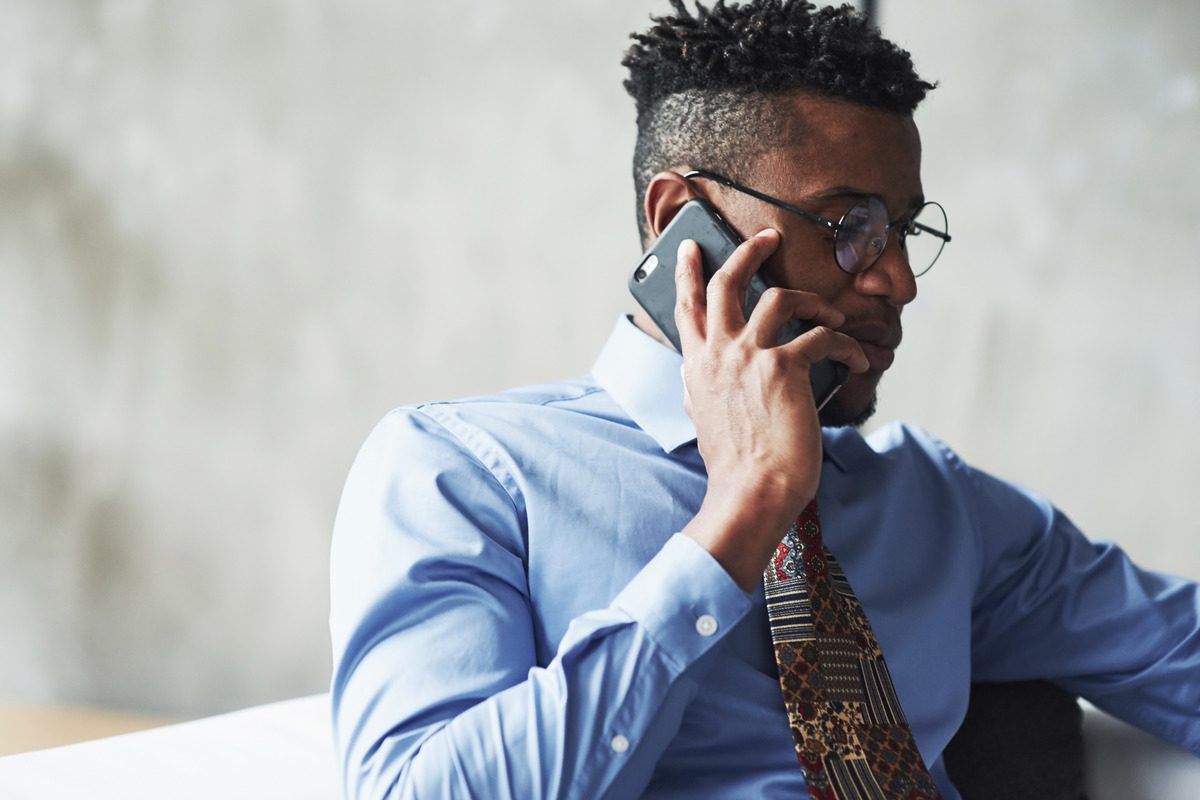 A photo showing father on the phone, possibly with a lawyer or family support service, appearing to discuss payment options or modifications to child support