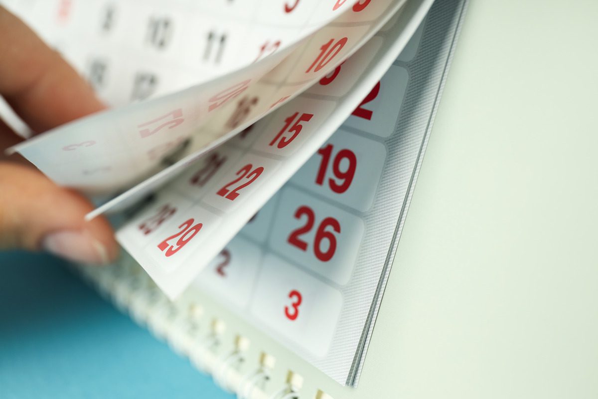 A person holds a calendar displaying a specific date, symbolizing the duration of a protective order