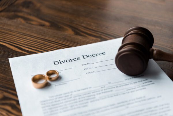 Divorce papers and a gavel symbolize the enforcement of a divorce decree in a legal context