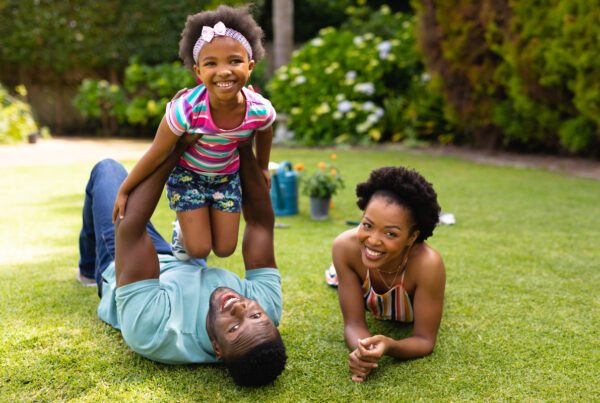 A joyful family enjoying time together in their yard, engaging in playful activities and creating lasting memories