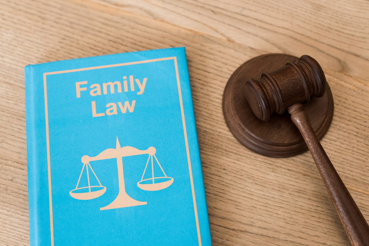 Family law book and gavel, symbolizing legal discussions on custody and co-parenting responsibilities