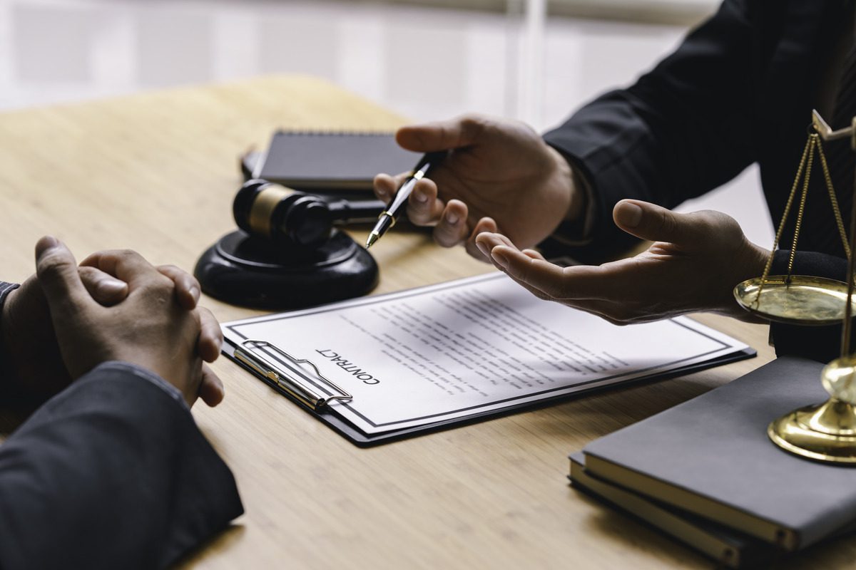 A lawyer discusses child support options with a client at a desk, providing legal guidance and support