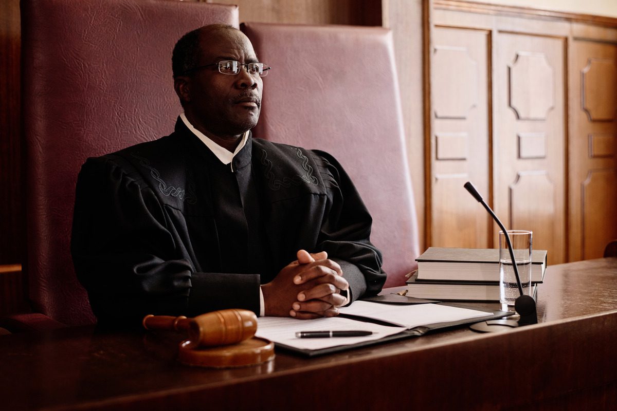 A judge presides over a courtroom, overseeing a temporary restraining order hearing with focused attention