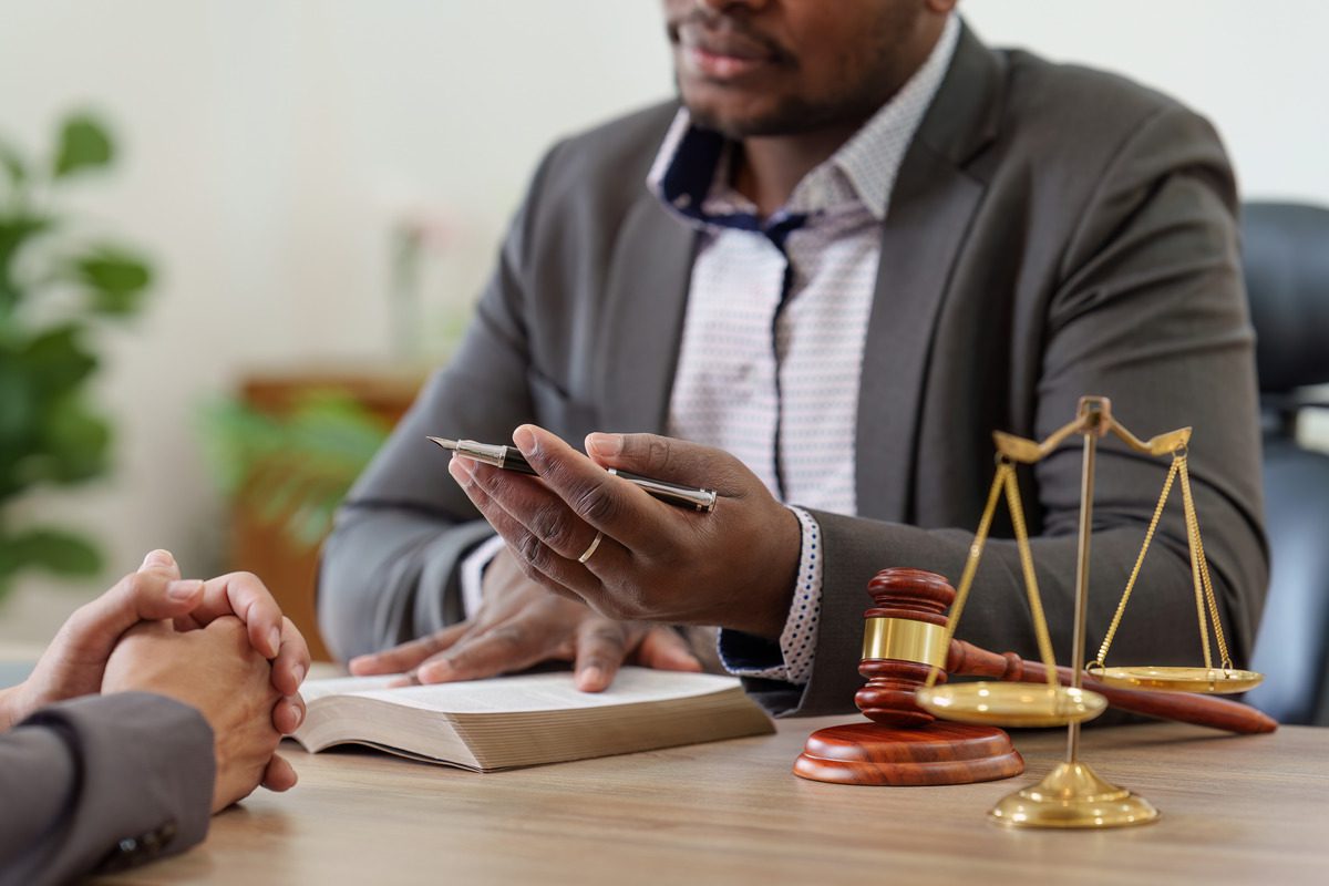 A lawyer discusses child support implications with a client in an office setting