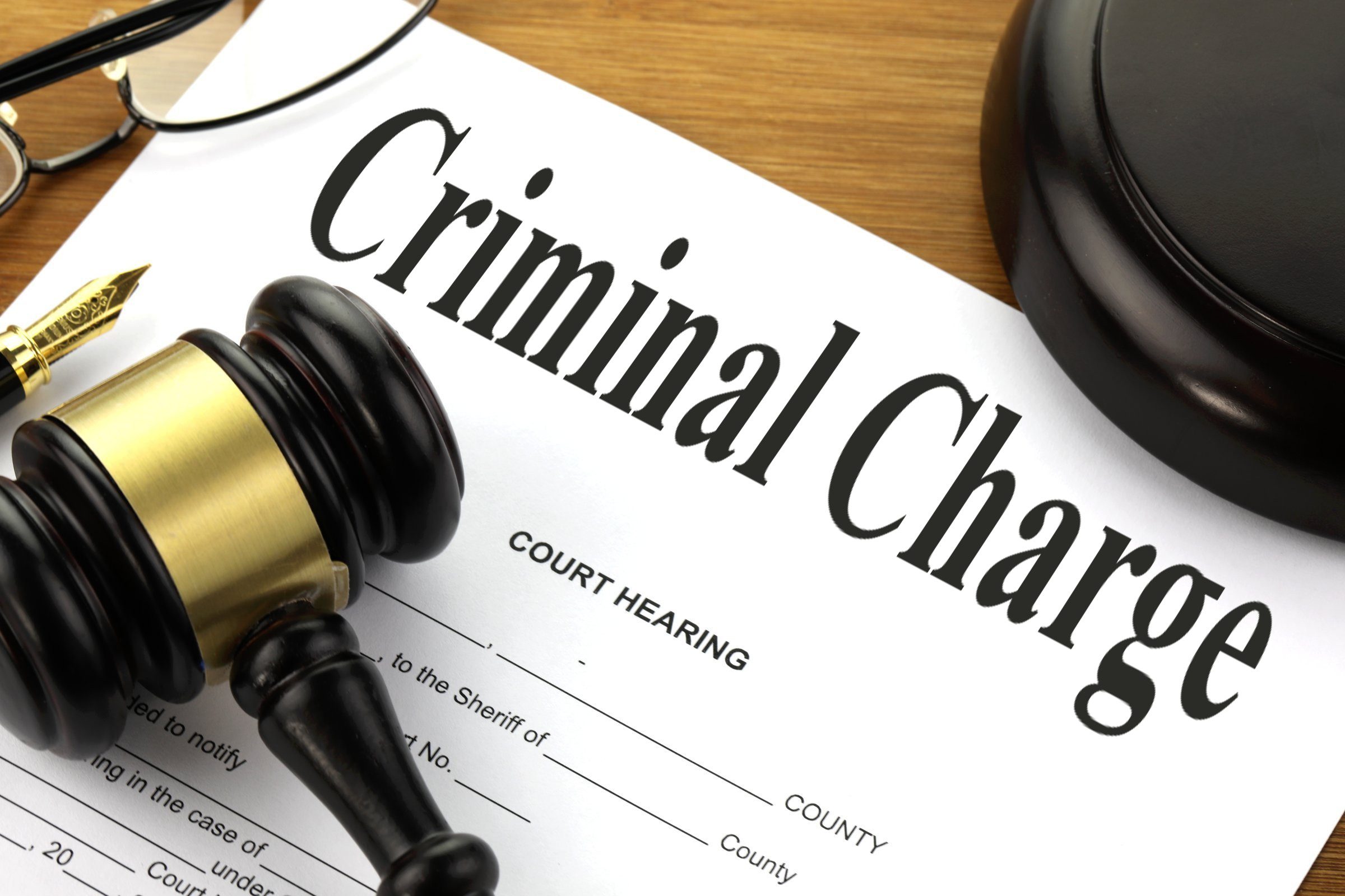 A criminal charge document on the judge's table