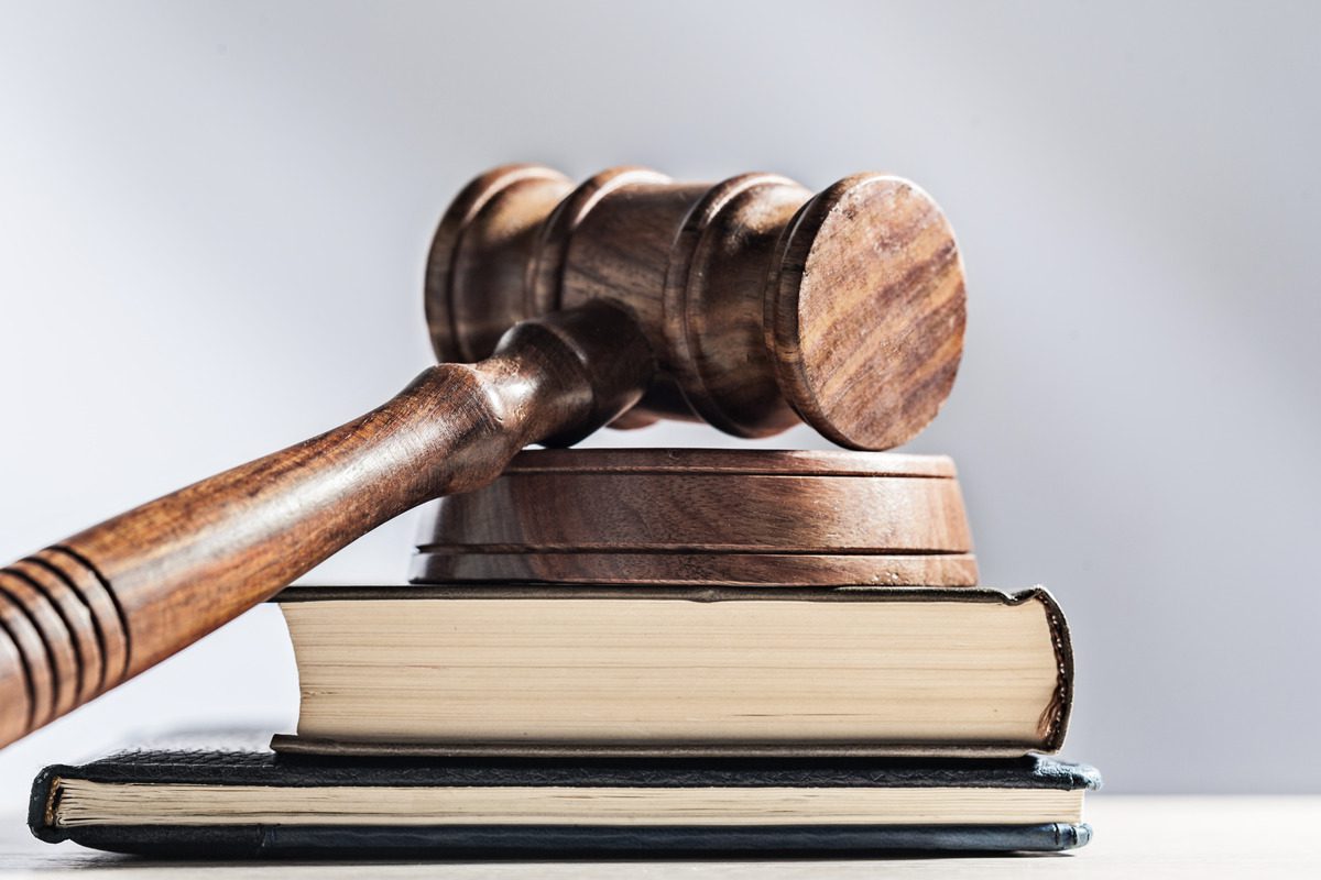 A judge's gavel rests on a stack of books, symbolizing legal authority and the complexities of child support and credit