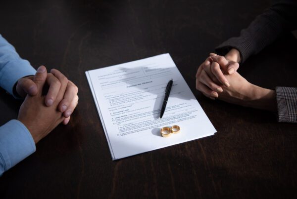 A couple discussing divorce with the documents between them
