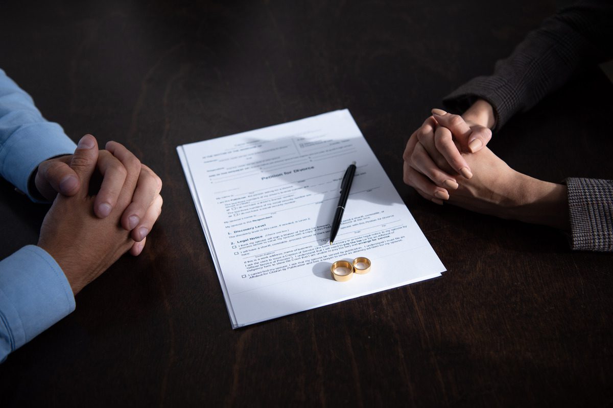 A couple discussing divorce with the documents between them