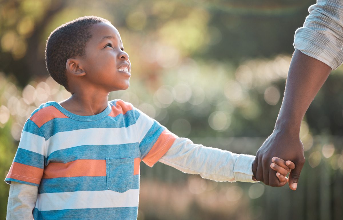 A child holding his parent
