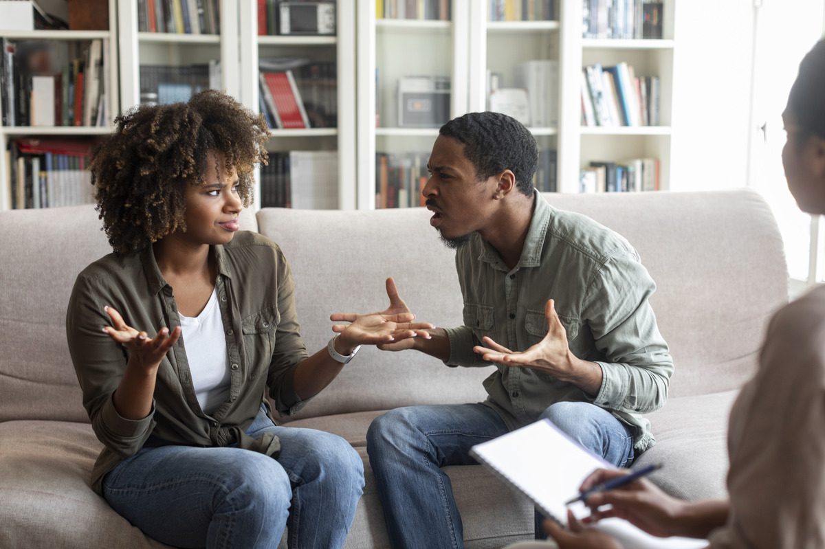 a couple arguing in front of a family counselor