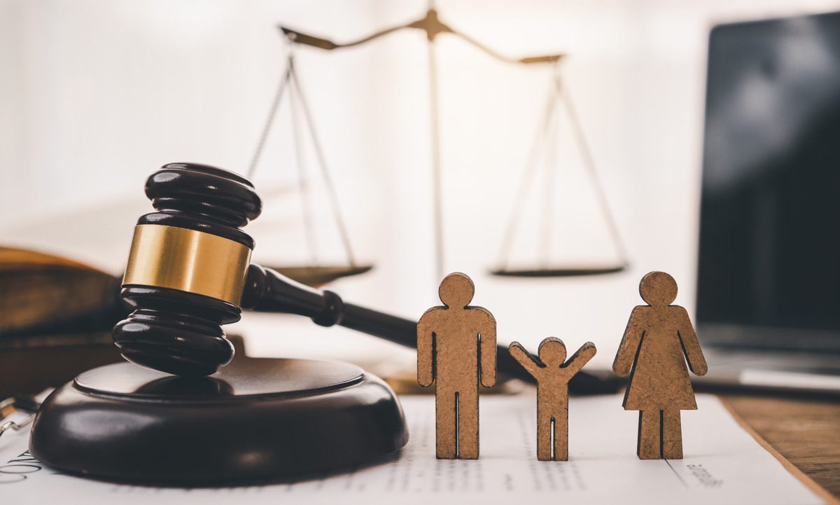 a gavel with a cardboard shaped like a family