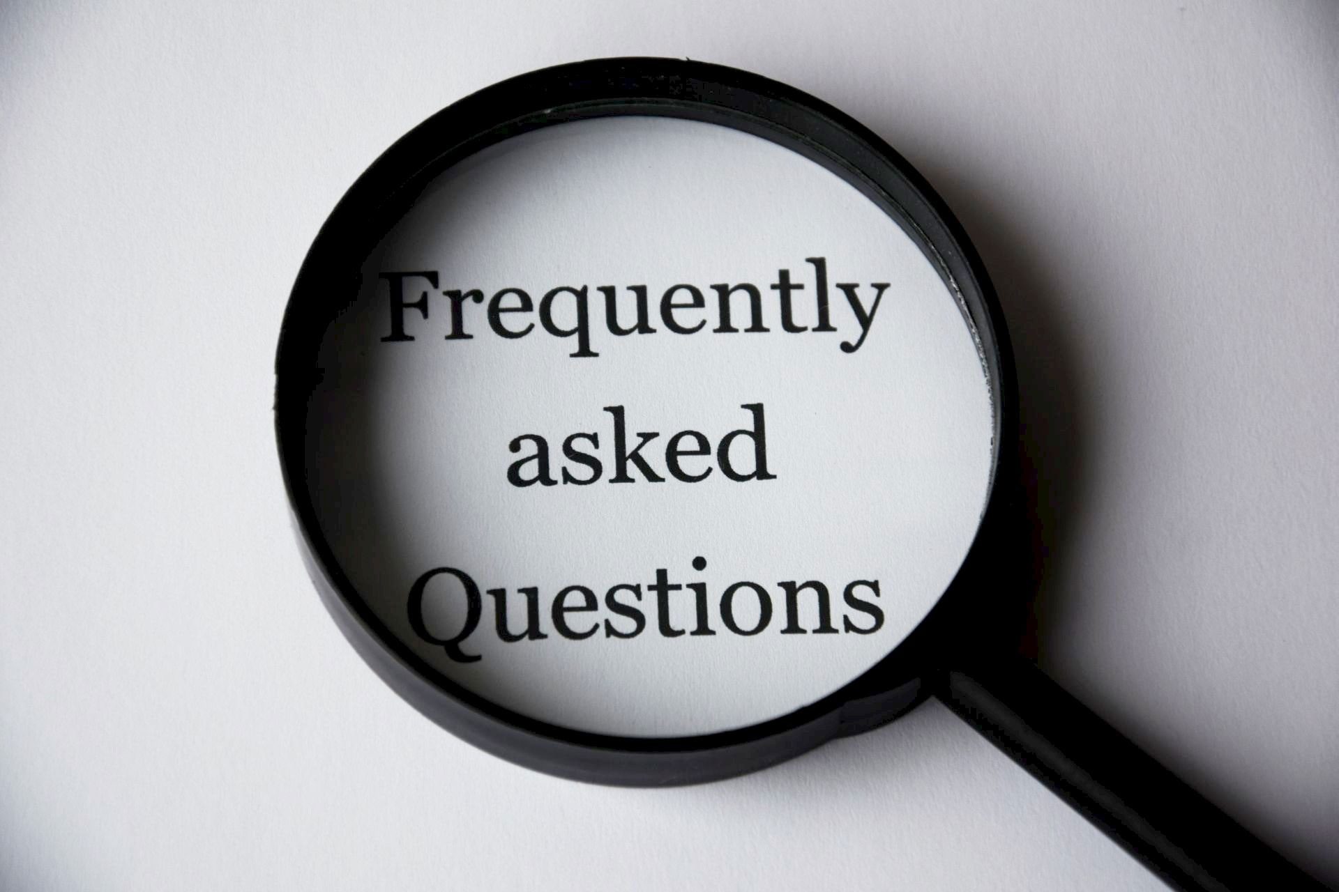 Frequently asked questions (FAQs) concept with magnifying glass, symbolizing common child support concerns