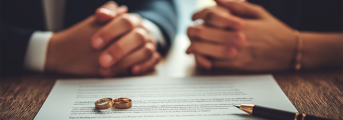 Married couple reviewing financial documents together, representing marital asset planning and prenuptial agreement discussions