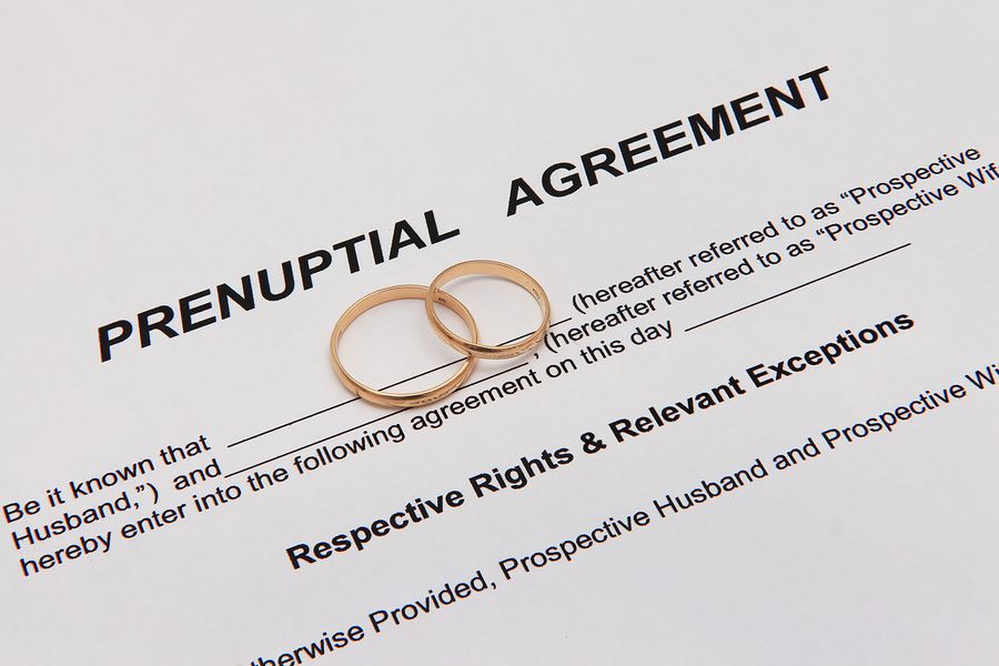Empty Prenuptial Agreement paper with wedding rings on top of it