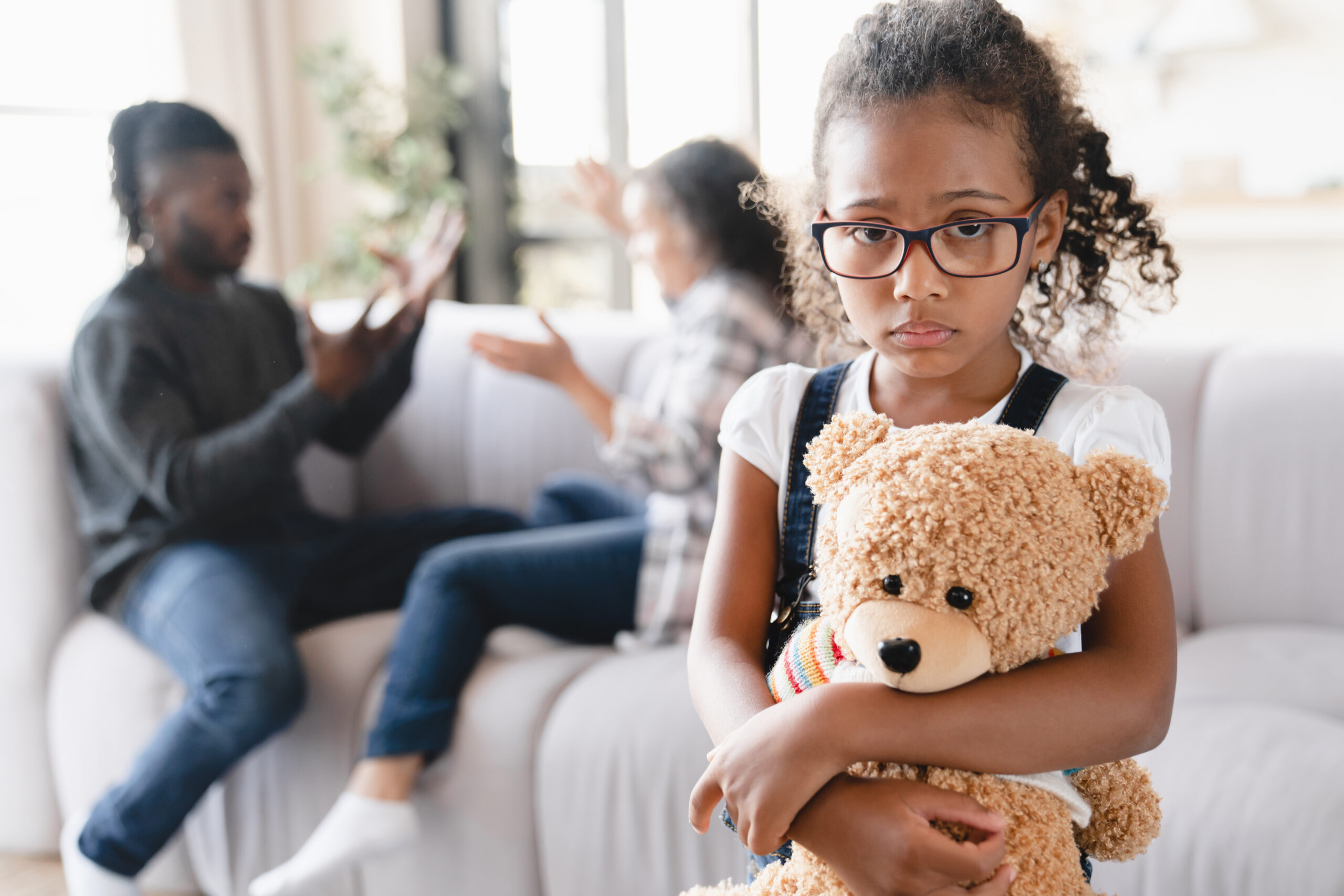 Sad Girl fears parents fighting on the background