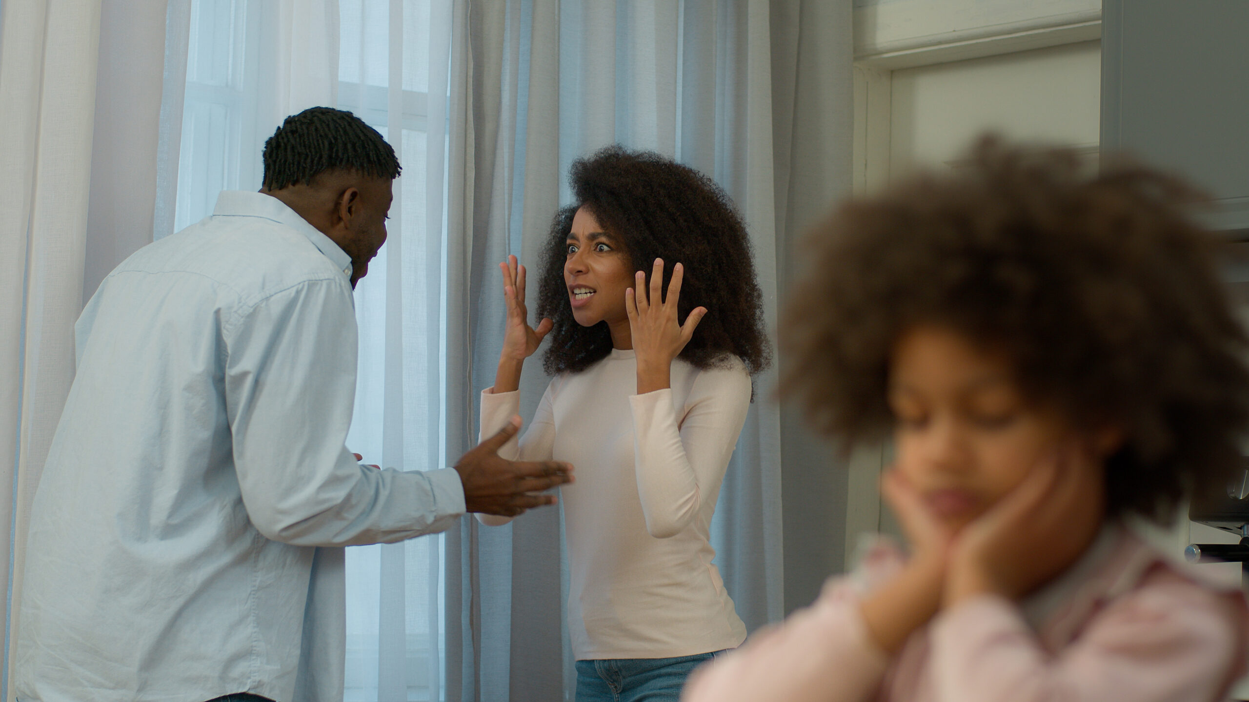Impact of family conflict on children, showing a distressed child while parents argue, representing domestic issues, family therapy needs, and childhood emotional health