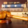 Wooden gavel and scales of justice representing professional legal services, courtroom litigation, and expert attorney representation for civil or criminal law cases