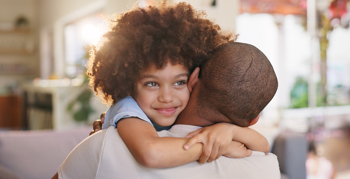 Child hugging parent at home with warm smile and affectionate embrace, representing family love, emotional support, parent-child bonding, and healthy family relationships.