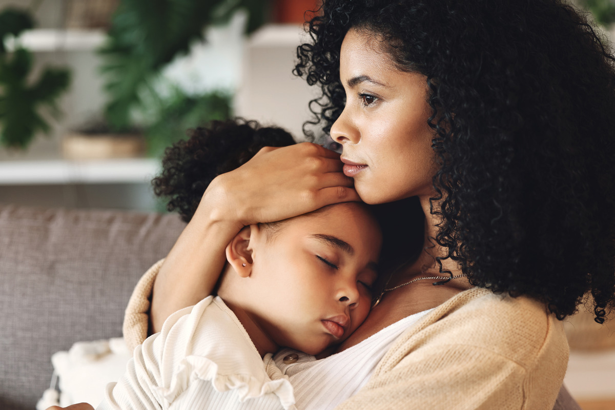 Loving parent comforting a sleeping child in their arms at home, symbolizing adoption, foster care, family bonding, child welfare, emotional support, and creating a safe and nurturing family environment