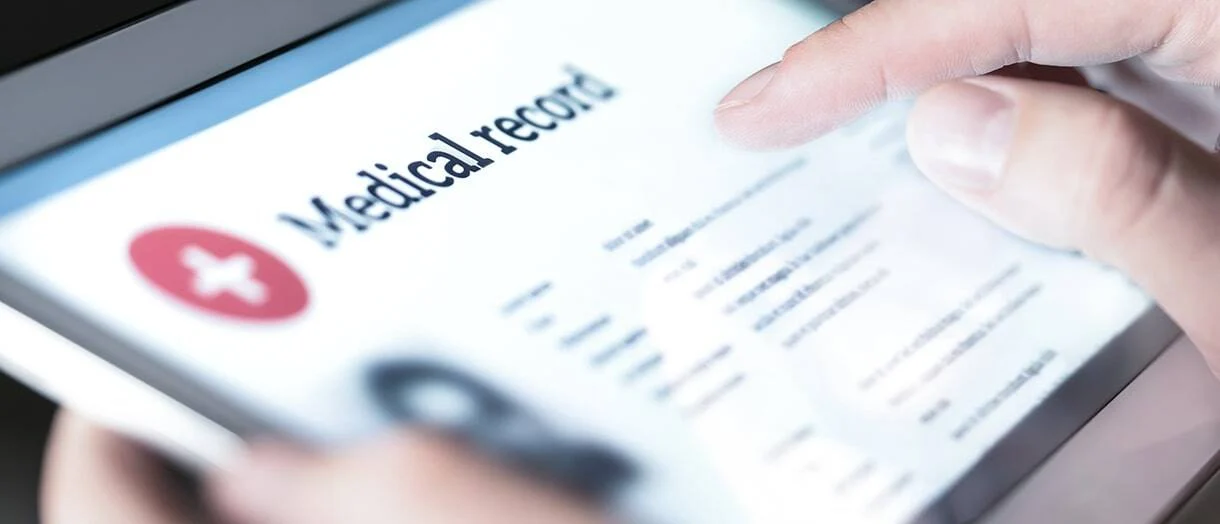 Person reviewing digital medical records on a tablet, representing healthcare documentation, patient medical history, electronic health records (EHR), medical evidence, and records used in personal injury and insurance claims