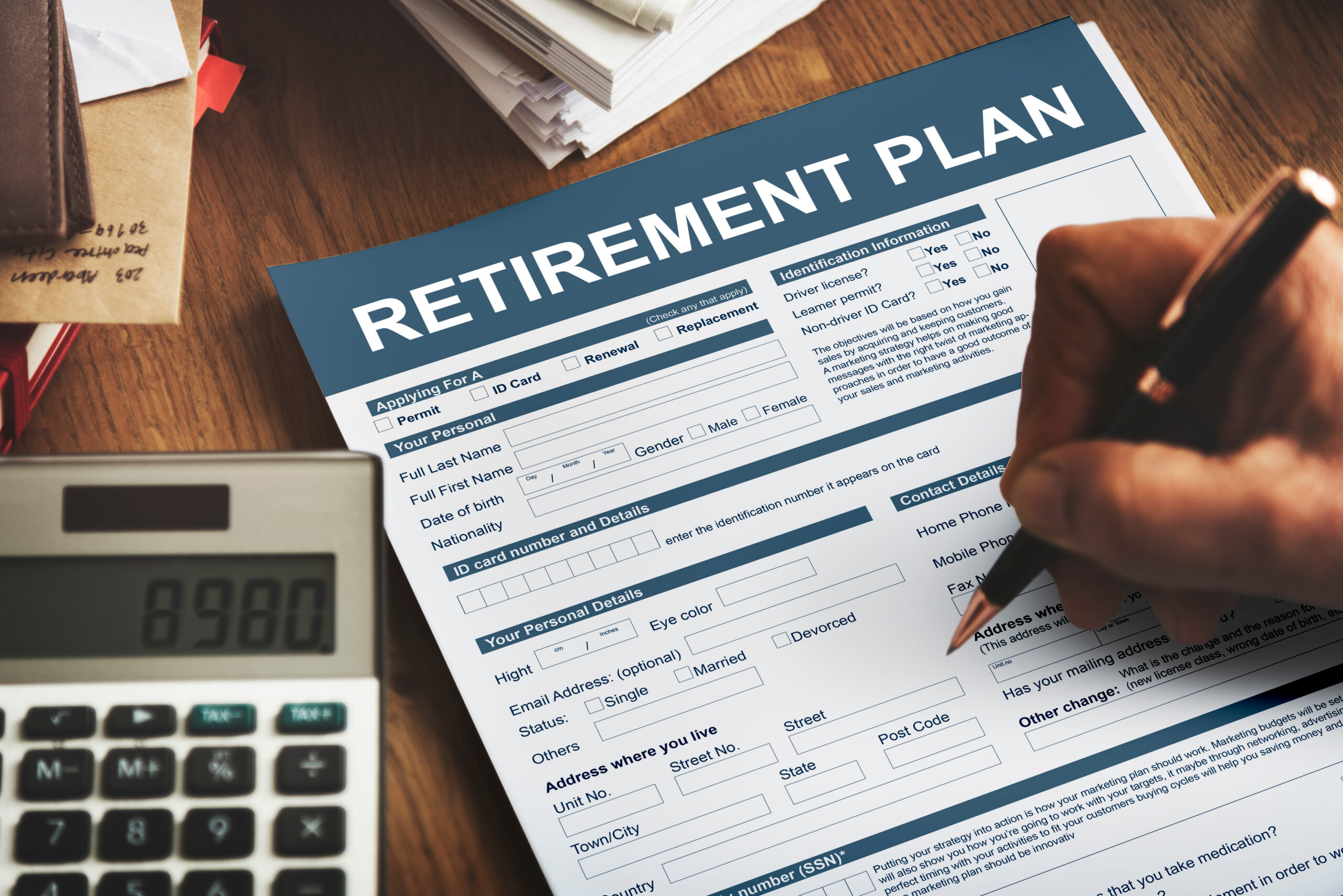 Person completing a retirement plan form beside a calculator, representing retirement accounts, retirement asset division, divorce financial planning, pension distribution, marital asset valuation, and family law property settlements